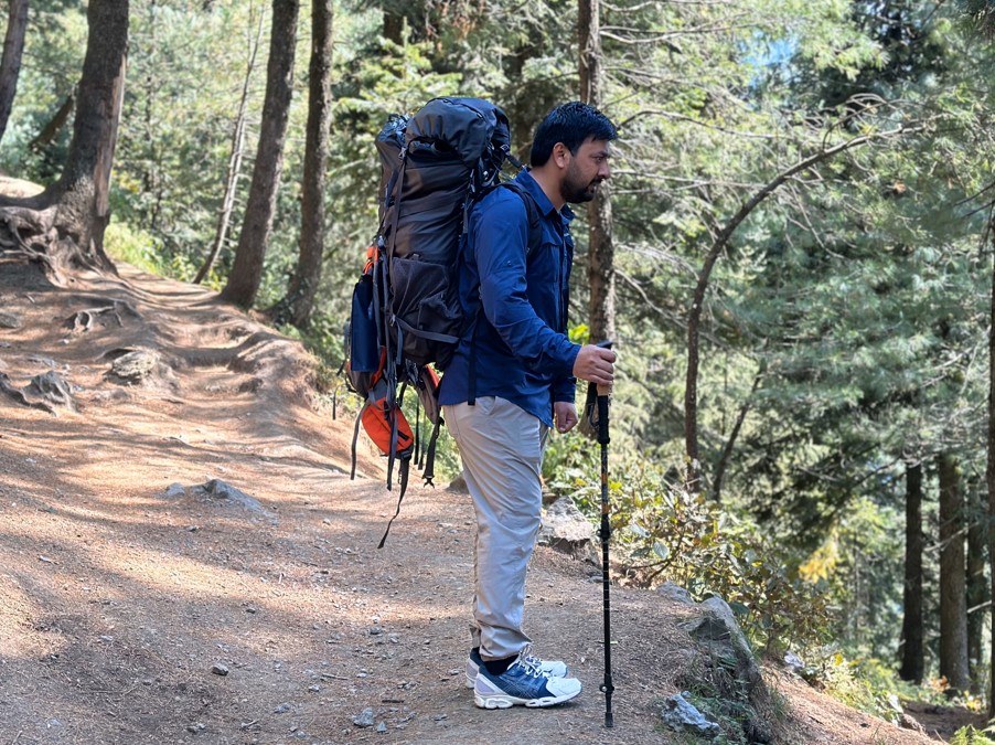 Hiking Shirt with hiking backpack and trekking poles on hiking trail