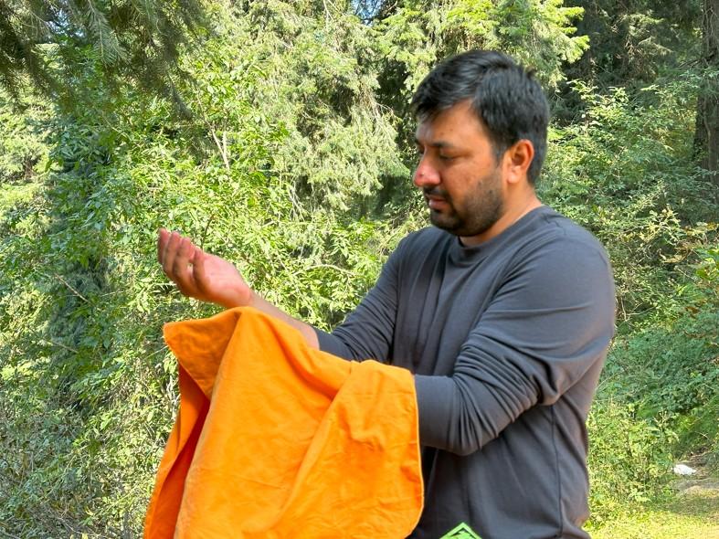 Sea to Summit Drylite Towel -Drying arms during outdoor gear test in forest setting