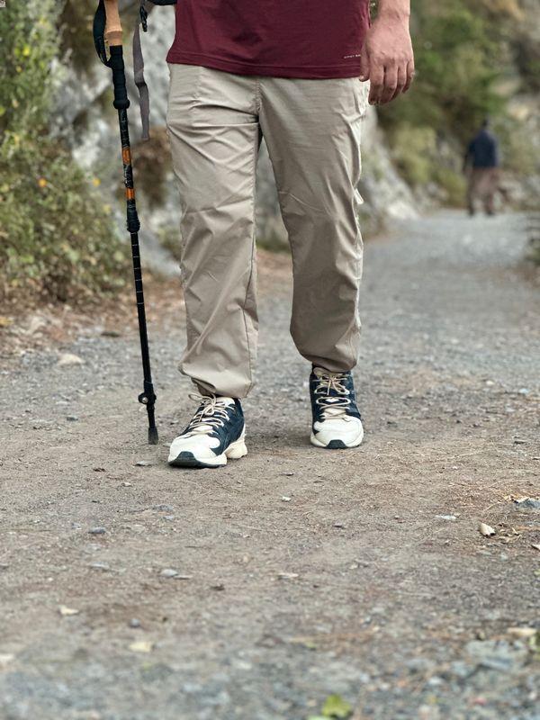 Using hiking poles while hiking on trail