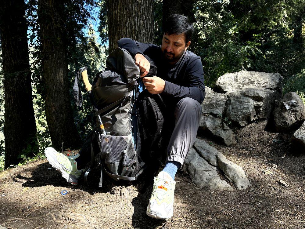 Sitting on hiking trail with hiking gear