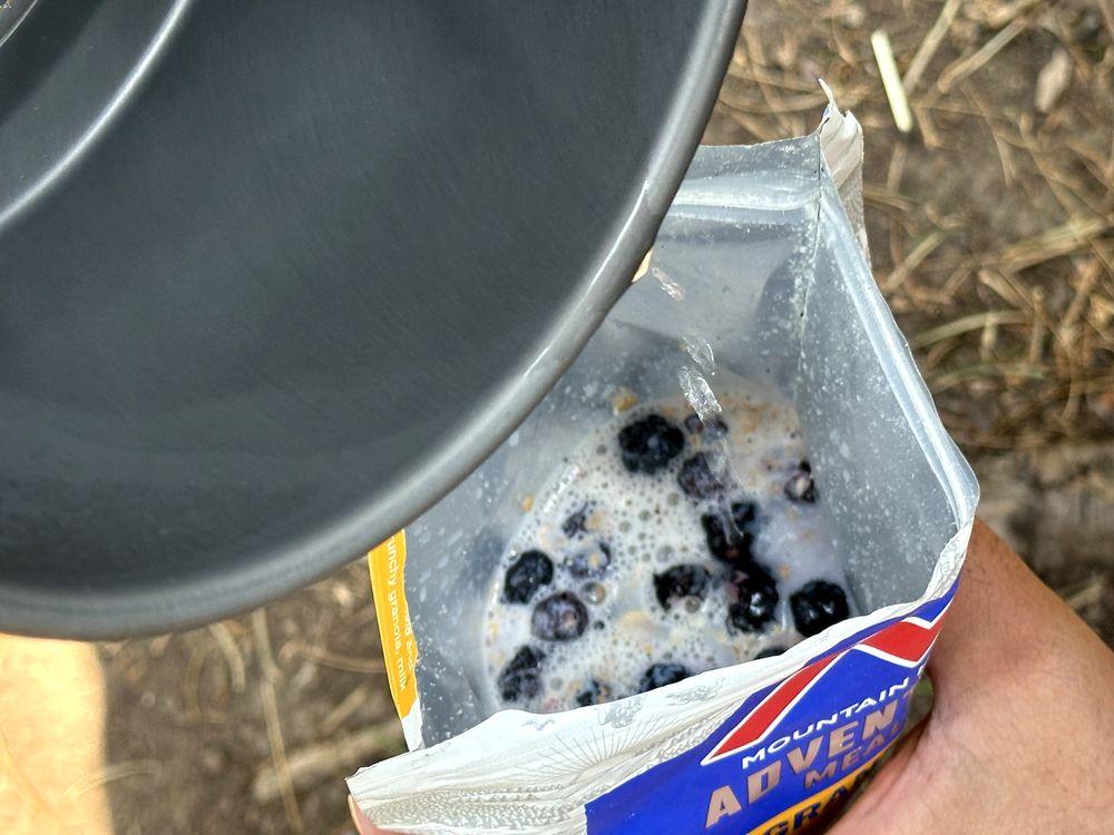 Preparing Mountain House Granola with Milk & Blueberries