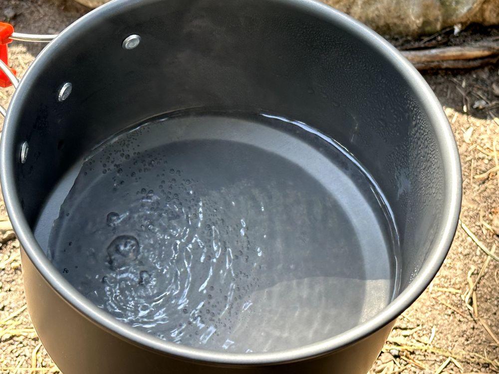 Boiling water in pot while camping