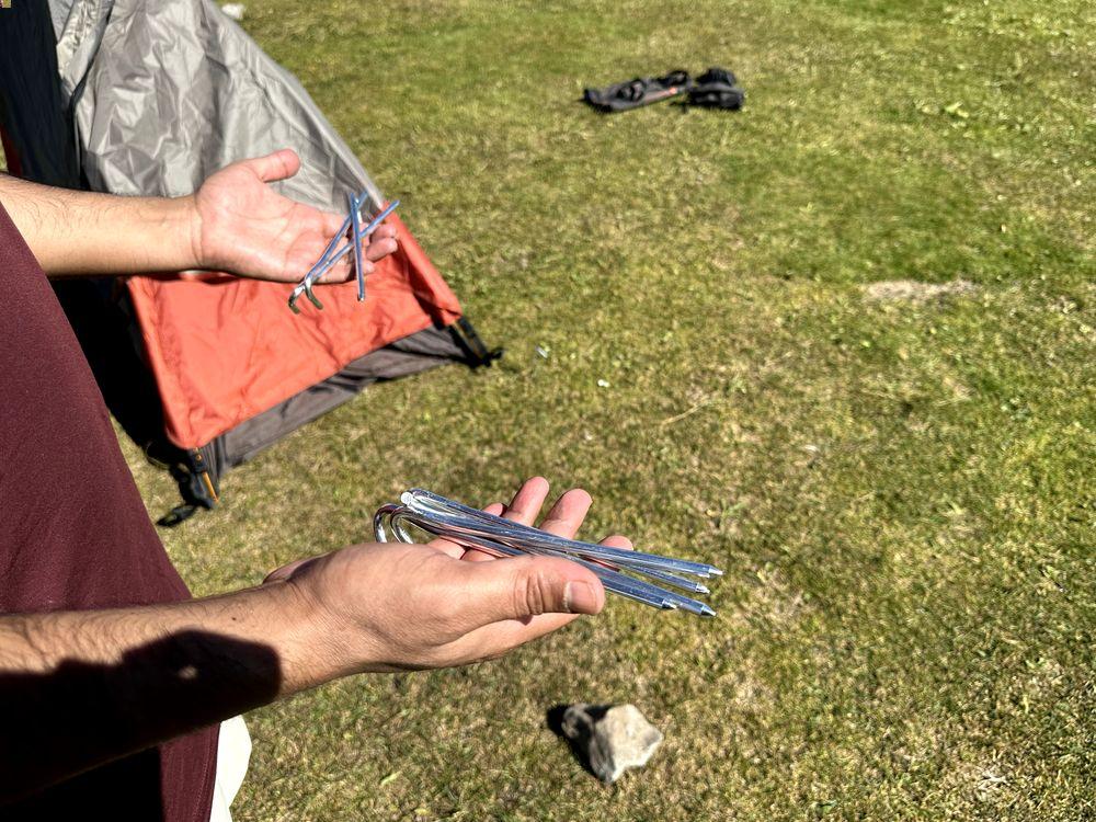 Holding lightweight tent pegs for setup during camping in wild
