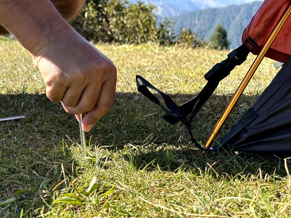 Inserting a tent stake for tent setup
