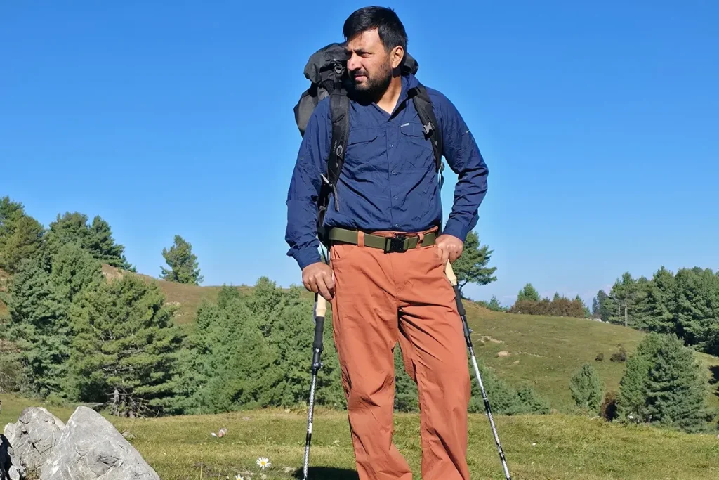 Wearing a synthetic hiking shirt while backpacking on a rocky trail