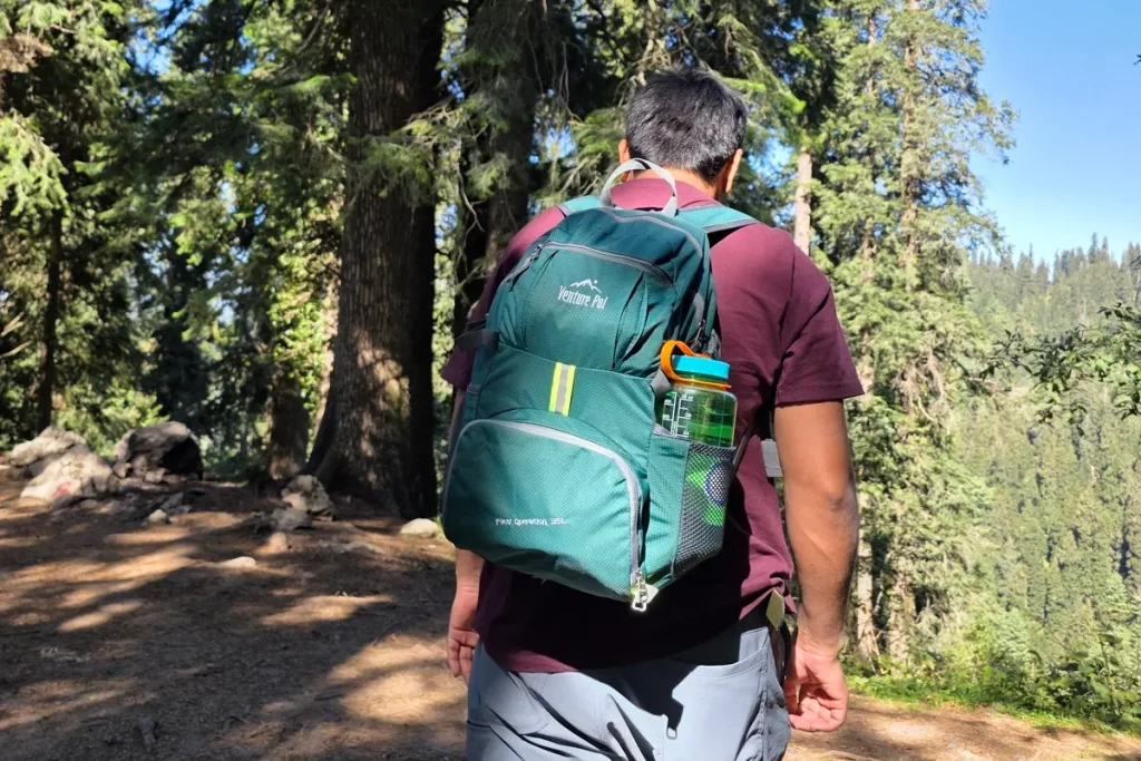 Nalgene Wide Mouth bottle carried in the side pocket of a hiking daypack on a forest trail