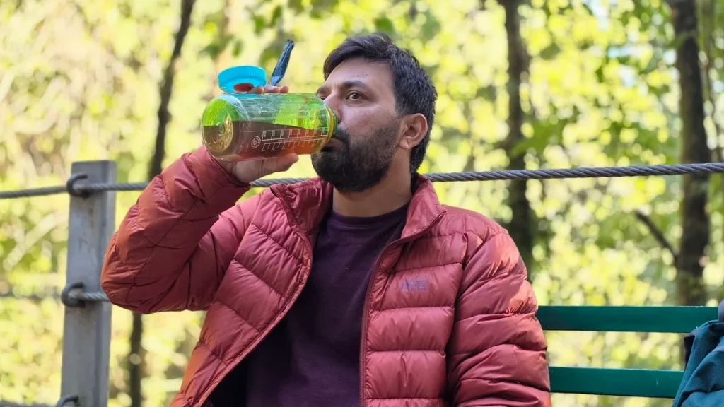 Drinking from a Nalgene Wide Mouth water bottle during a hiking break