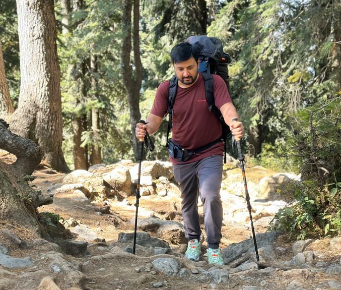 Demonstrating proper trekking pole use on an uphill hike