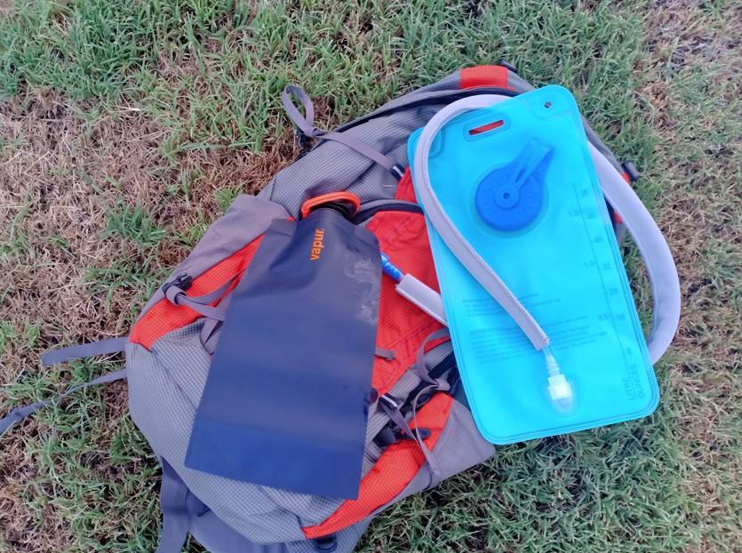 hydration bladder and water bottle - on hiking backpack in backcountry