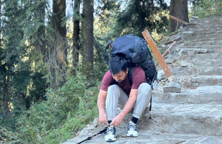 Backpacking backpack - I am tying my shoelaces on a steep mountain trail with a fully loaded hiking backpack, surrounded by dense forest