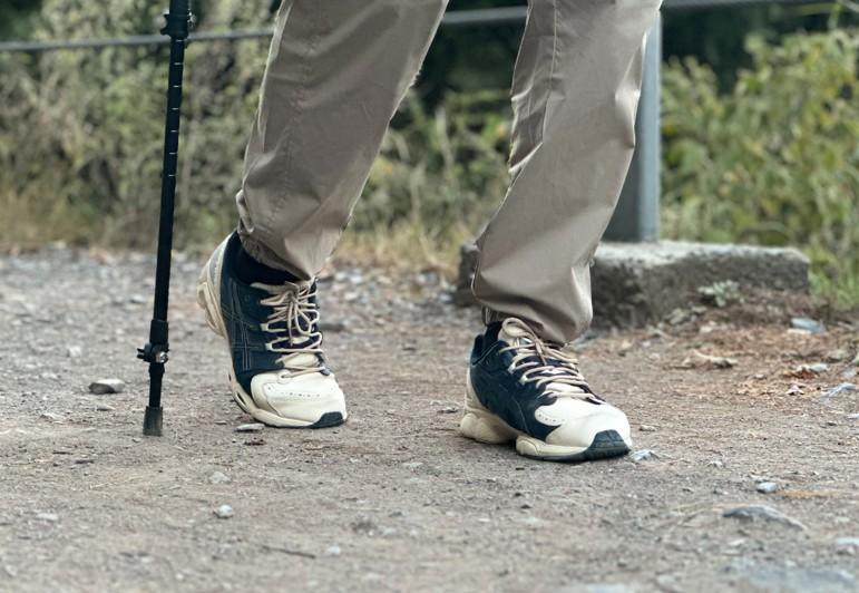 Proper trekking pole placement while hiking on an even trail