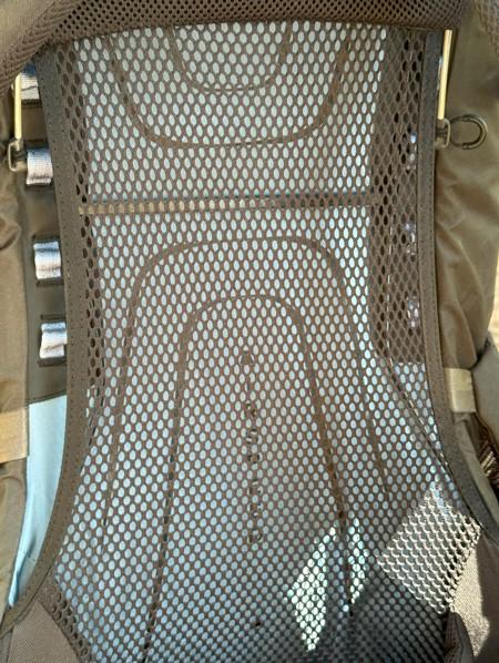 Close-up of ventilated backpack suspension system with mesh back panel, designed for airflow and comfort during hiking and backpacking trips.