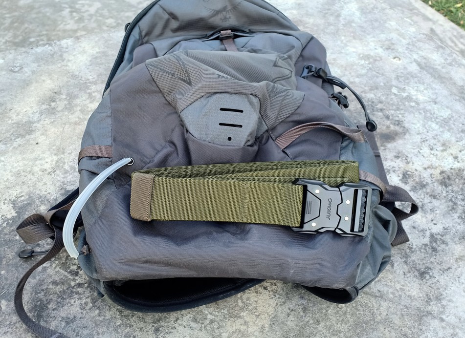 JUKMO Seatbelt Tactical Belt placed on a hiking backpack