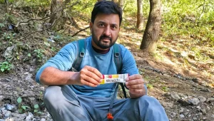 Holding Skratch Labs Sport Hydration Drink Mix during a hike