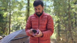 Wearing the REI Co-op 650 Down Jacket at a campsite